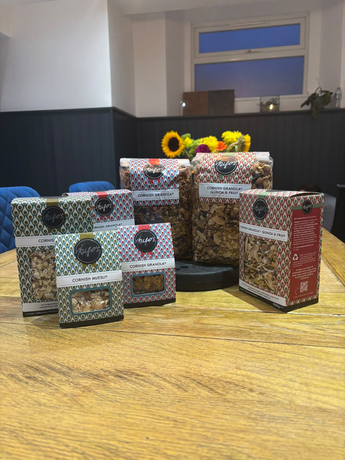 A display of Hugo's Breakfast boxes and refill bags on a shop counter, as they'd look on your shelves